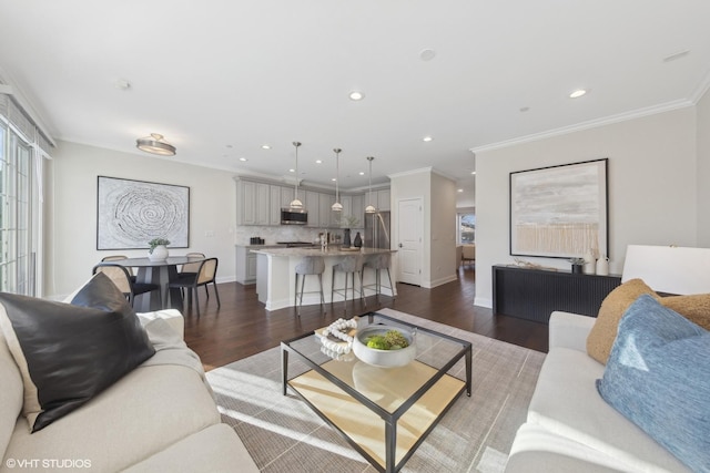 living room with crown molding and dark wood-type flooring