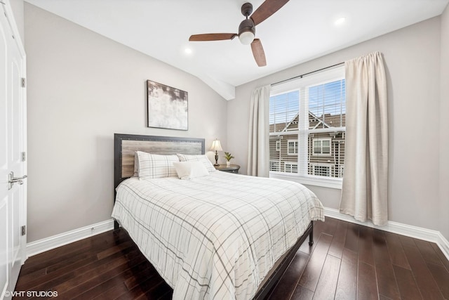 bedroom featuring ceiling fan, dark wood-type flooring, and vaulted ceiling