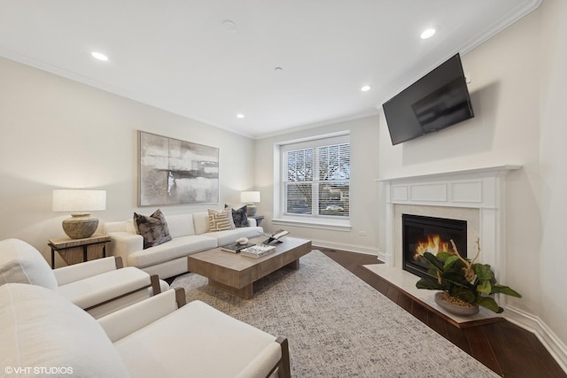 living room with crown molding, a fireplace, and dark wood-type flooring