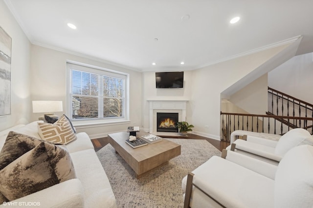 living room with wood-type flooring and crown molding