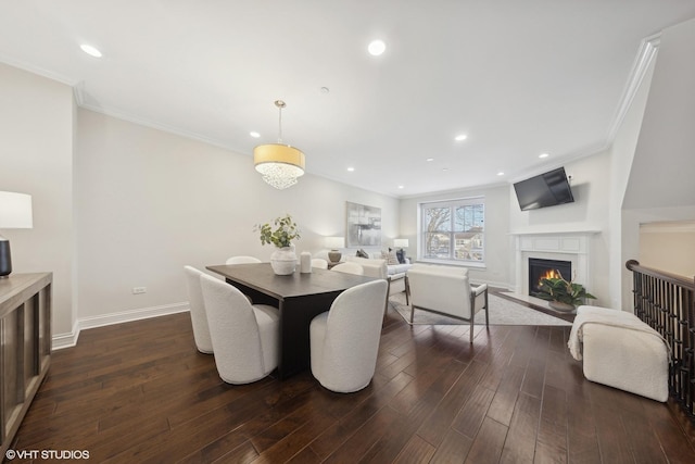 dining room with dark hardwood / wood-style floors and crown molding