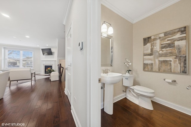 bathroom featuring hardwood / wood-style floors, sink, toilet, and crown molding