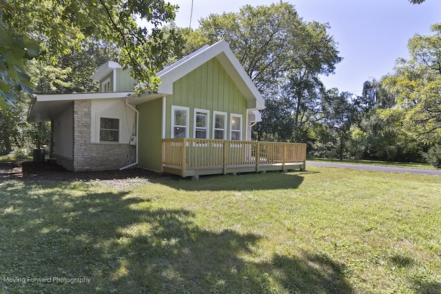 back of house with a lawn, cooling unit, and a deck