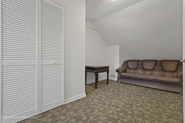 interior space featuring carpet and vaulted ceiling