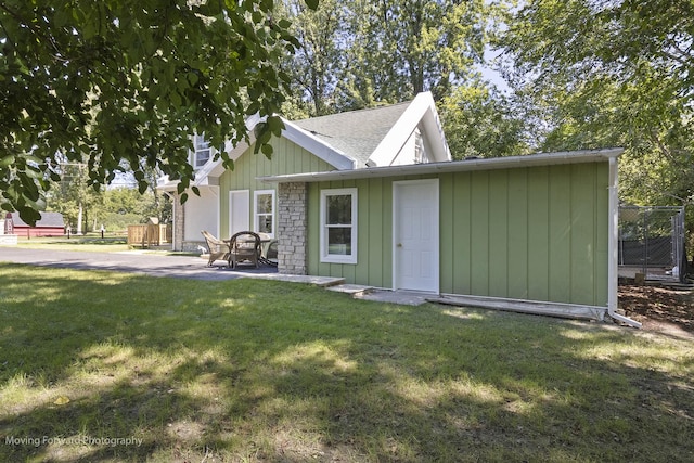 view of front facade with a patio area and a front lawn