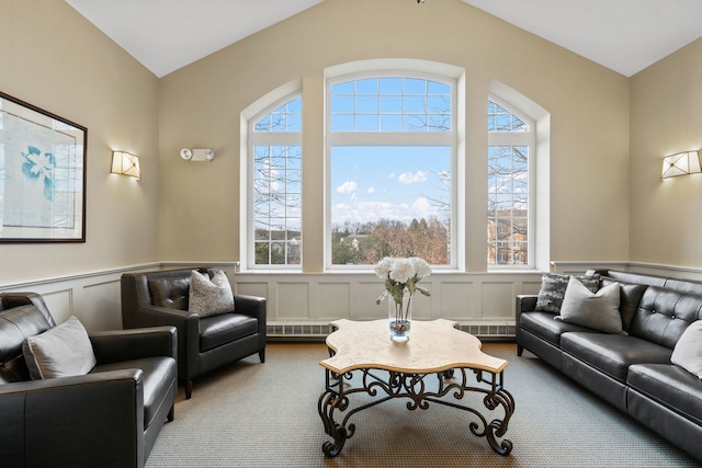 living room with light colored carpet, a wealth of natural light, and lofted ceiling