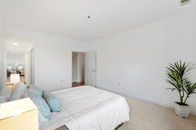 bedroom featuring light carpet