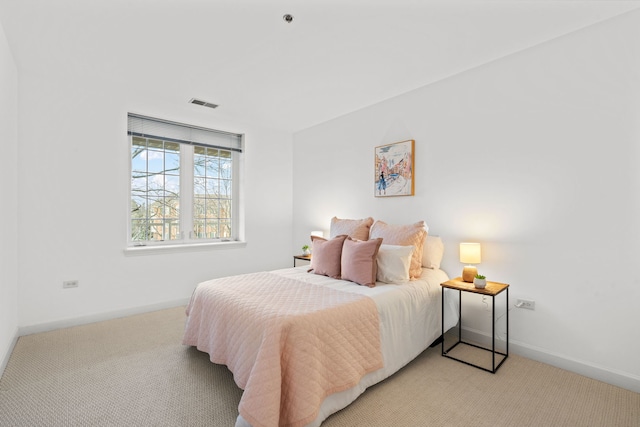 bedroom with light colored carpet