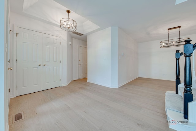 living room featuring a chandelier and light hardwood / wood-style flooring