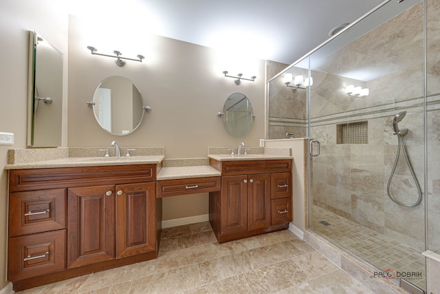 bathroom with vanity and a shower with shower door