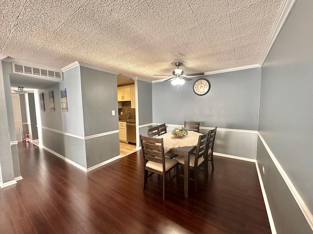 dining area with ceiling fan, sink, ornamental molding, and hardwood / wood-style flooring