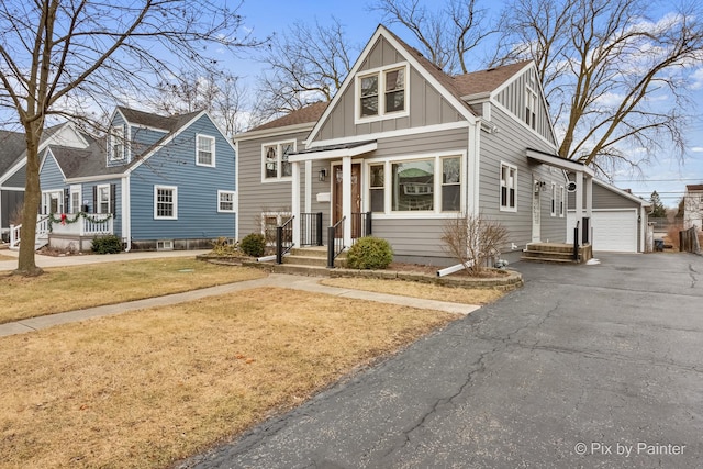 view of front of home with an outbuilding, a garage, and a front yard