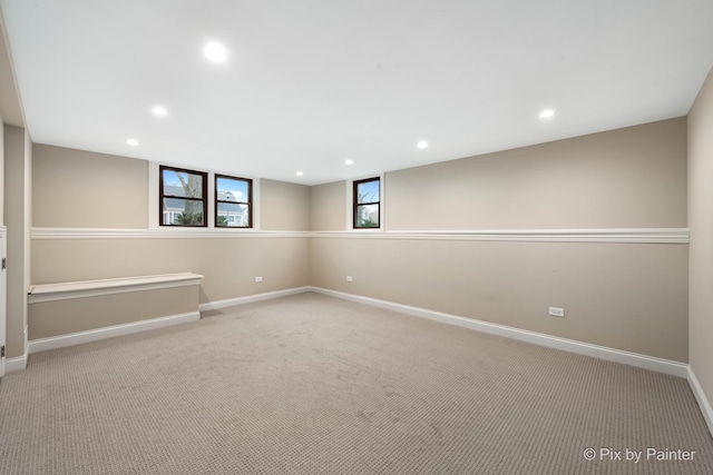 basement featuring light colored carpet