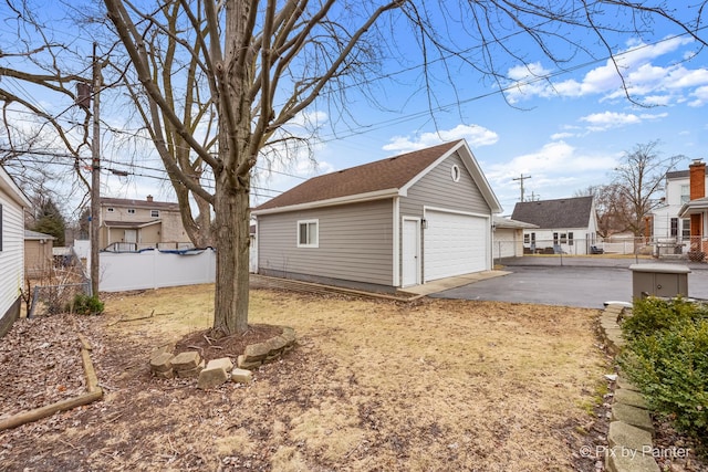 exterior space featuring an outbuilding and a garage