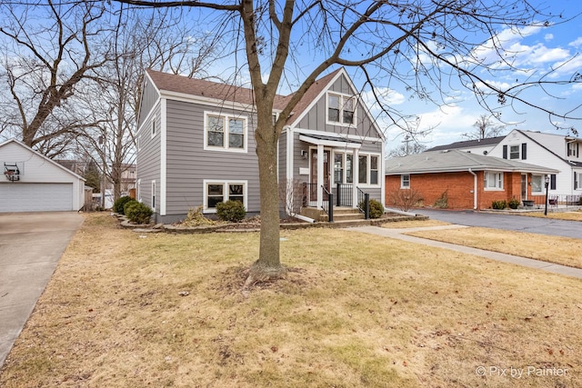 view of front of property featuring an outbuilding, a garage, and a front lawn