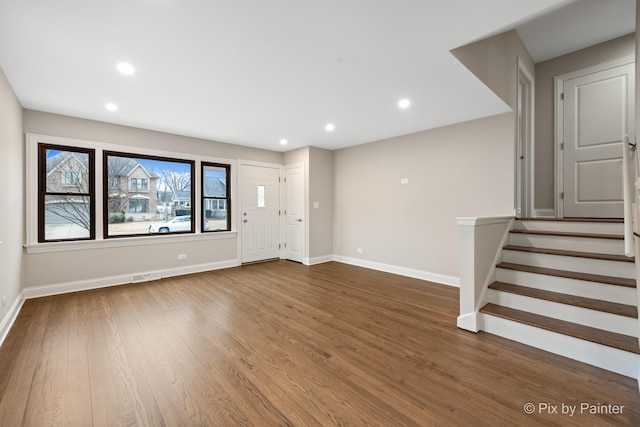 unfurnished living room featuring hardwood / wood-style flooring