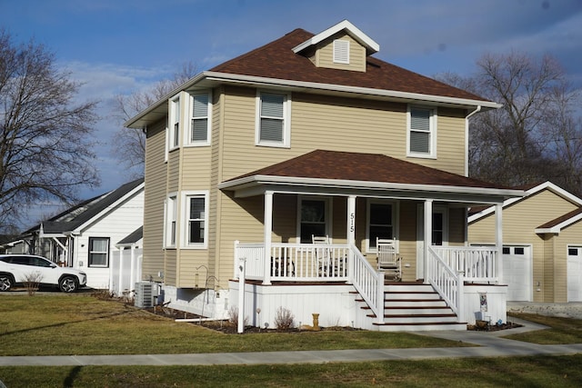 view of front of house featuring a garage, covered porch, a front lawn, and central air condition unit