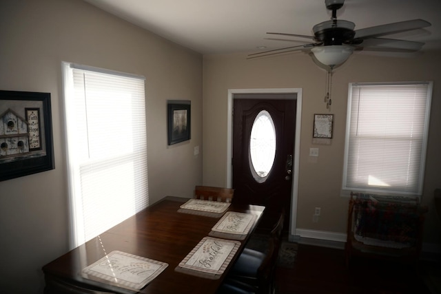 dining space with ceiling fan and dark hardwood / wood-style floors