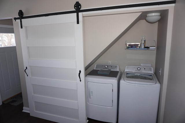 laundry area featuring a barn door and separate washer and dryer