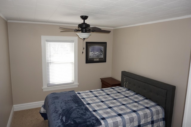 carpeted bedroom with crown molding and ceiling fan