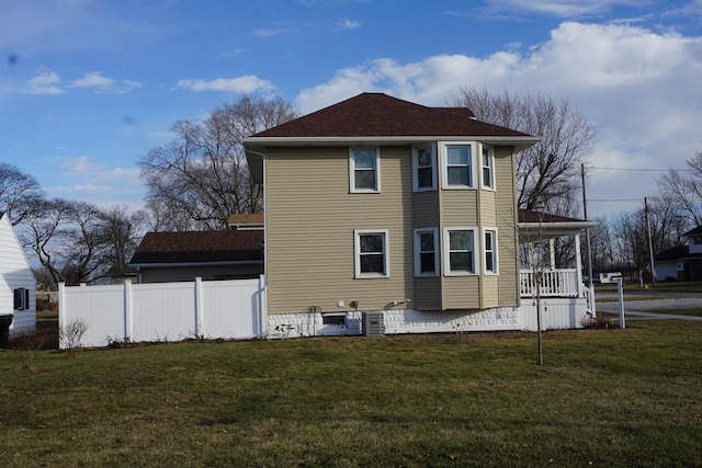 back of property with central AC, a lawn, and a porch