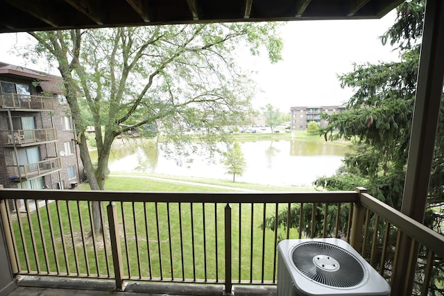 balcony with a water view and central AC unit