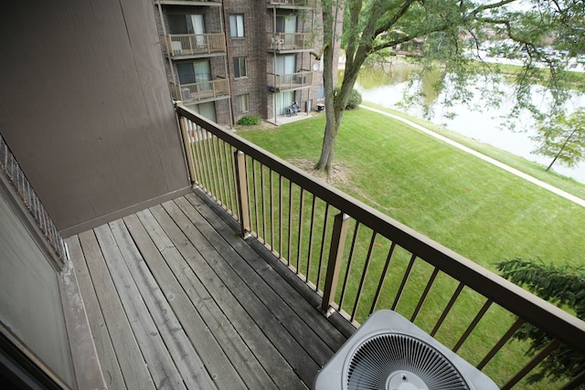 wooden terrace with a water view and central air condition unit