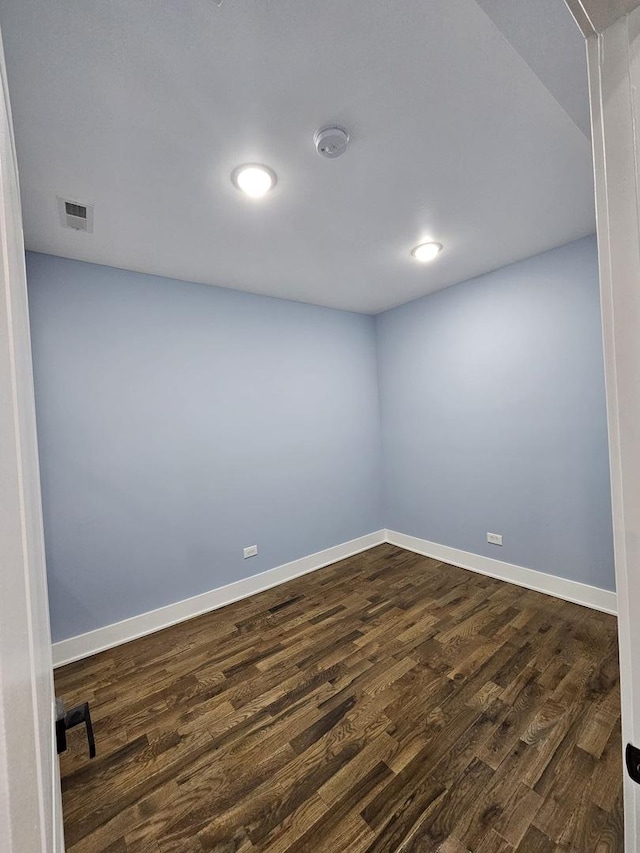 unfurnished room featuring dark wood-type flooring