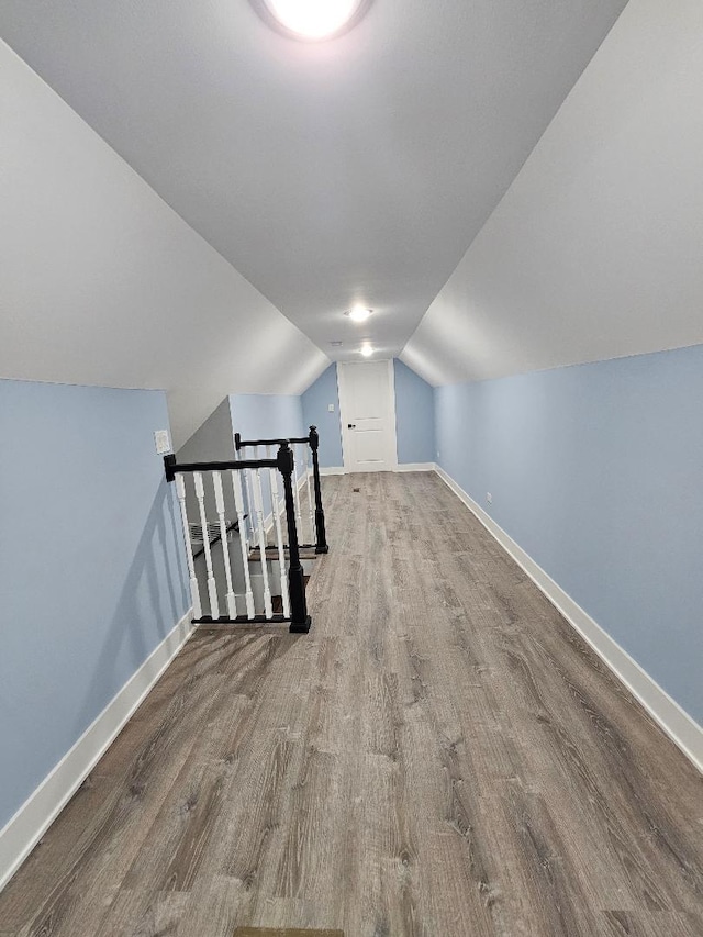 bonus room featuring hardwood / wood-style flooring and vaulted ceiling