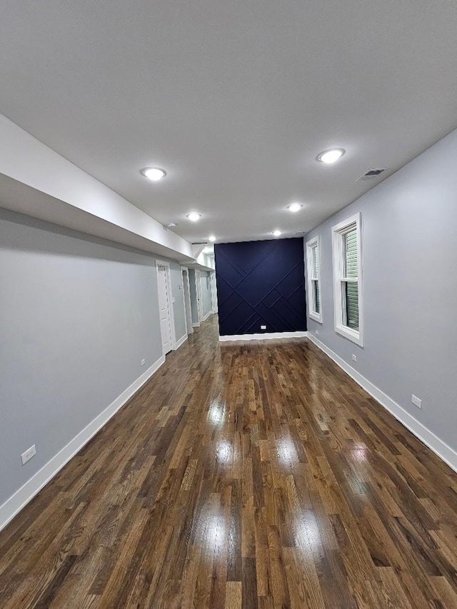 basement with dark hardwood / wood-style flooring