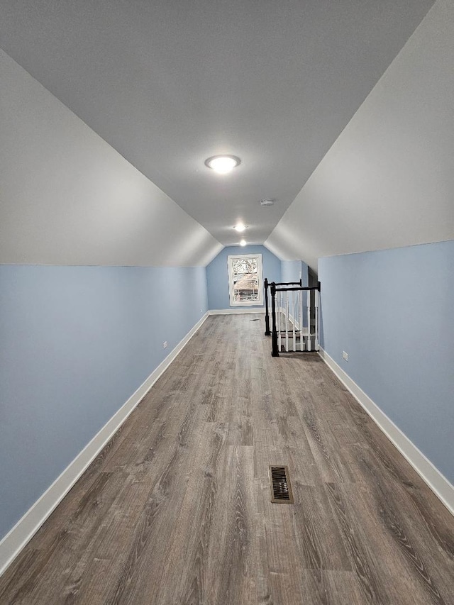 bonus room featuring lofted ceiling and hardwood / wood-style flooring