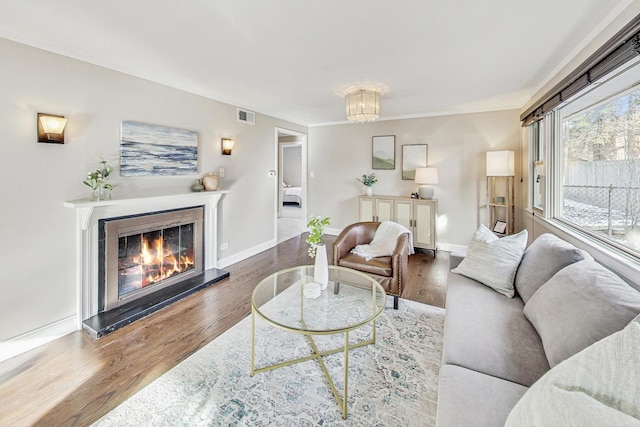 living room with an inviting chandelier and hardwood / wood-style floors