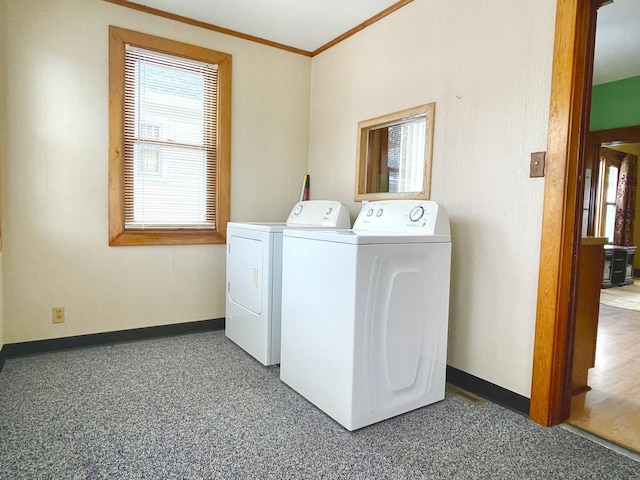 washroom featuring crown molding and washer and clothes dryer