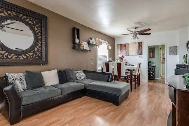 living room featuring ceiling fan and light hardwood / wood-style flooring