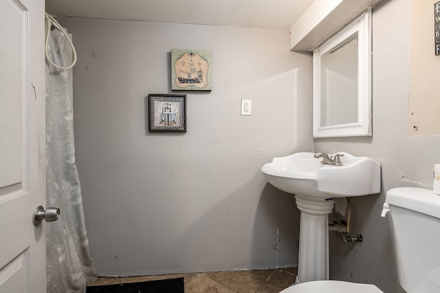 bathroom with tile patterned flooring and toilet