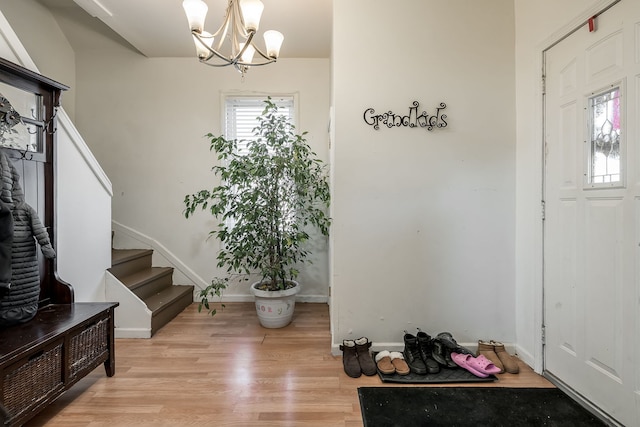 foyer with a chandelier and light wood-type flooring