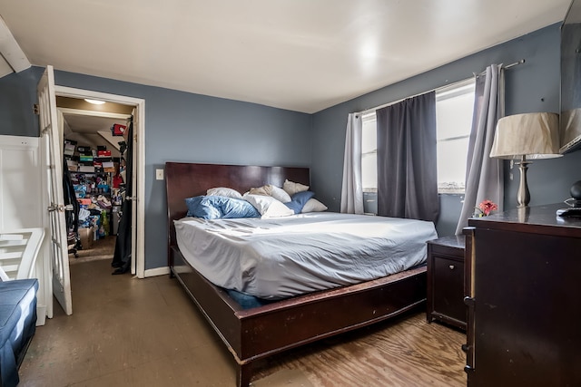 bedroom with dark hardwood / wood-style flooring