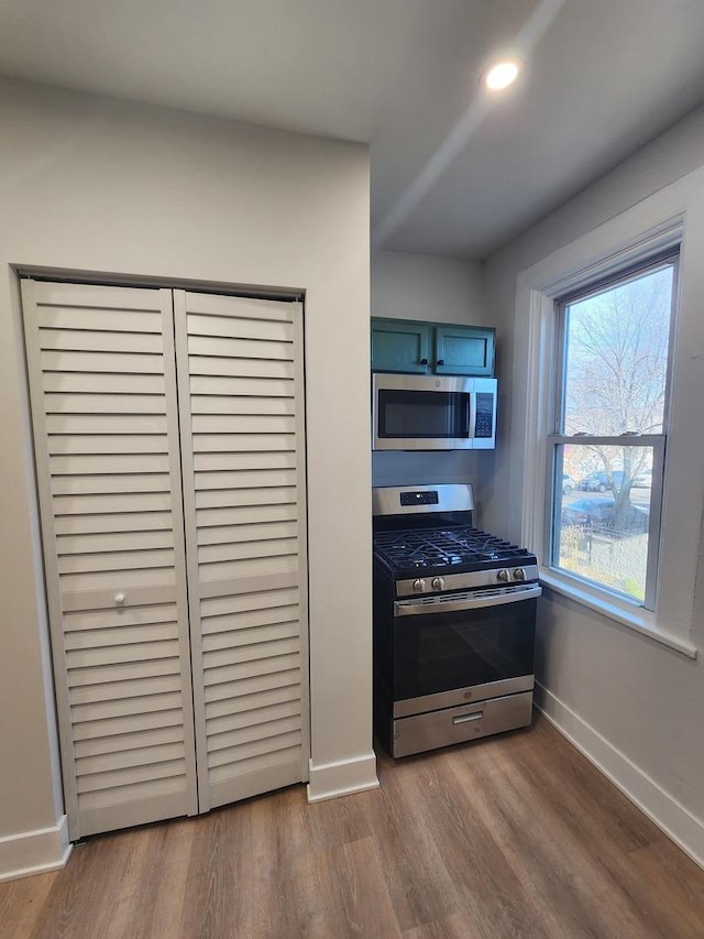 kitchen featuring a healthy amount of sunlight, appliances with stainless steel finishes, and light hardwood / wood-style floors