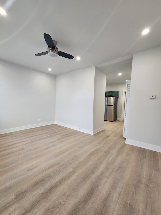 unfurnished room with ceiling fan and light hardwood / wood-style floors