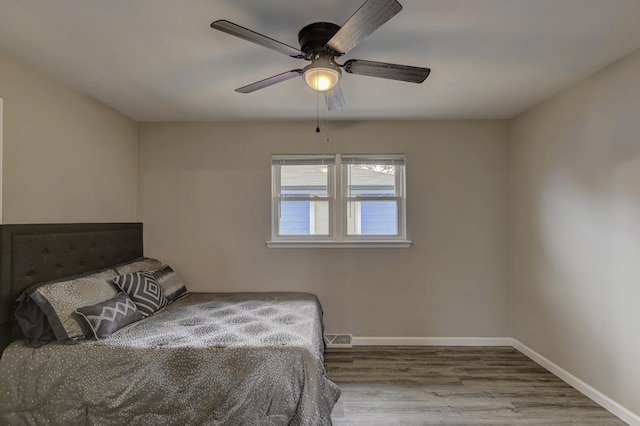 bedroom with hardwood / wood-style floors and ceiling fan