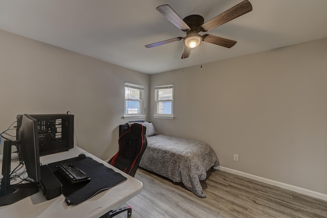 bedroom with hardwood / wood-style floors and ceiling fan