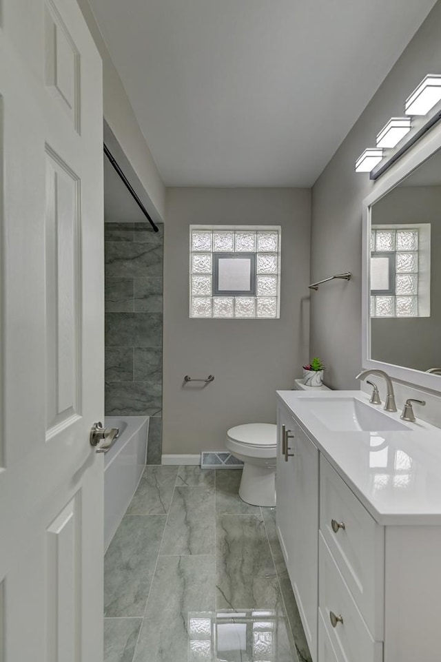 full bathroom featuring shower / tub combination, vanity, and toilet