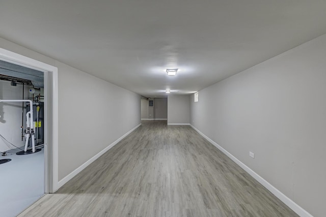 basement featuring gas water heater and light wood-type flooring