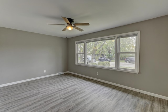 unfurnished room featuring ceiling fan and light wood-type flooring