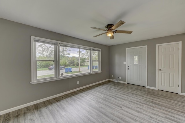 interior space with ceiling fan and light hardwood / wood-style flooring