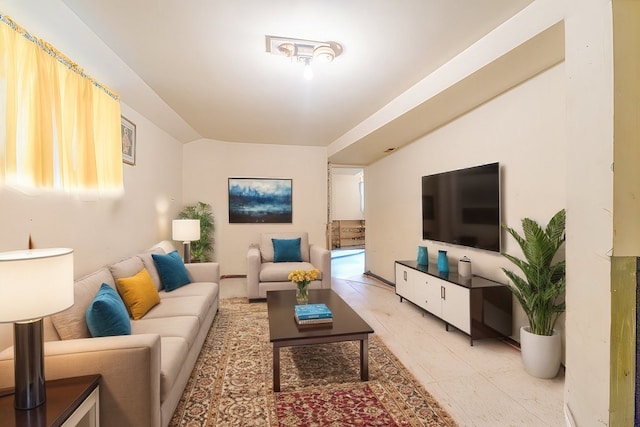 living room featuring vaulted ceiling