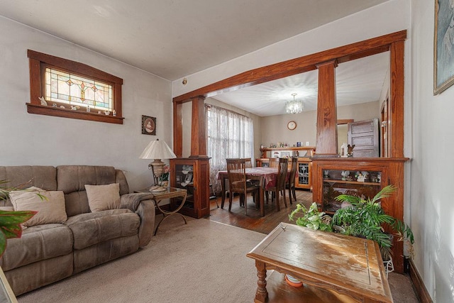 living room with carpet floors and an inviting chandelier