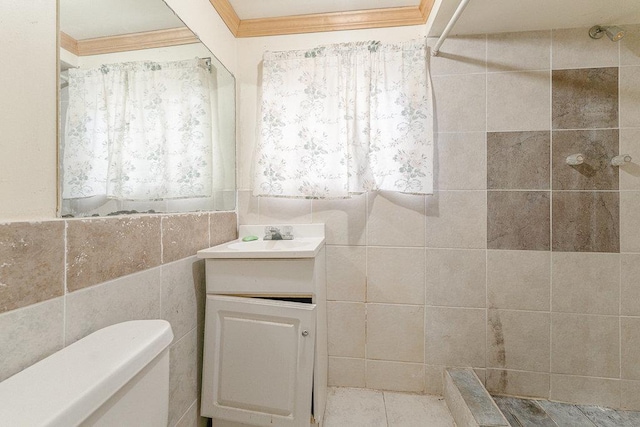 bathroom with vanity, walk in shower, crown molding, and tile walls