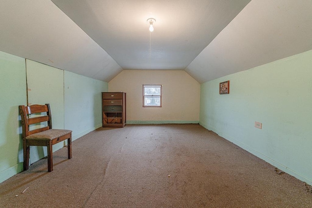 bonus room featuring light colored carpet and vaulted ceiling