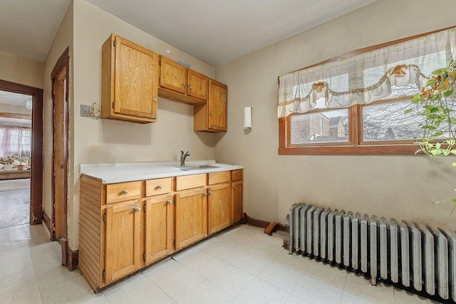 kitchen featuring radiator heating unit and sink